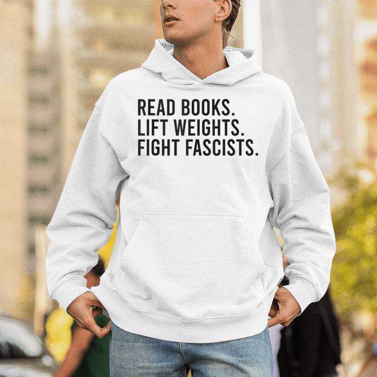 Read Books Lift Weights Fight Fascists Reading Activism Unisex Hoodie Read Books Lift Weights Fight Fascists Reading Activism Unisex Hoodie