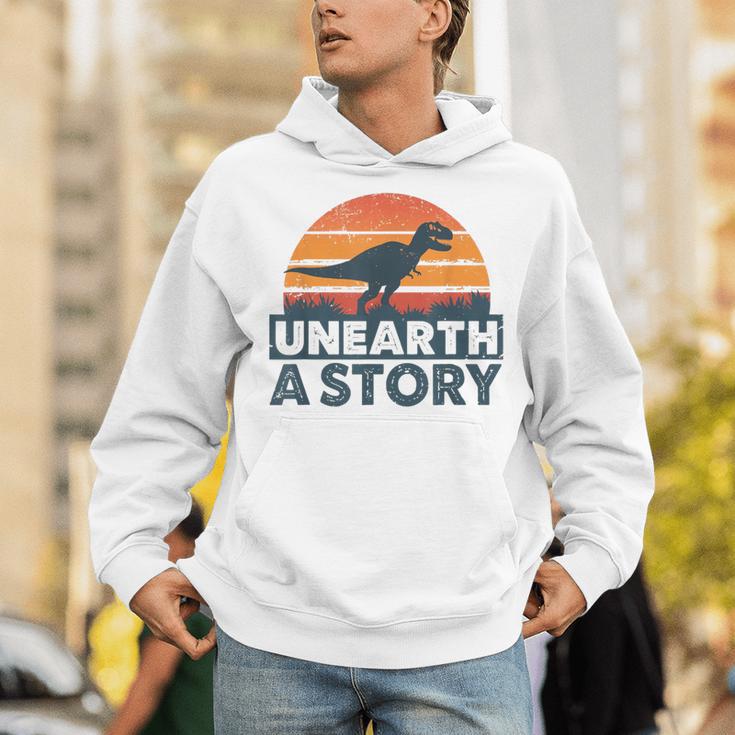 Unearth A Story Dinosaur Reader Book Lover 2026 Unisex Hoodie Unearth A Story Dinosaur Reader Book Lover 2026 Unisex Hoodie