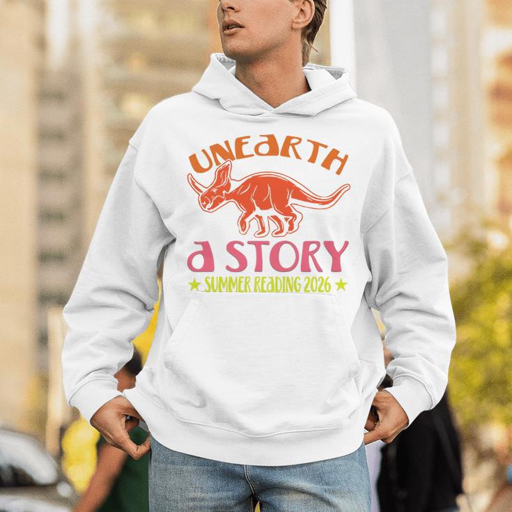 Unearth a Story Summer Reading 2026 Triceratops Dino Book Premium Tri-Blend Unisex Hoodie