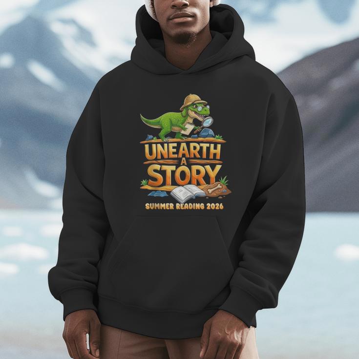 Unearth a Story Dinosaur Reading Books Summer 2026 Unisex Hoodie Unearth a Story Dinosaur Reading Books Summer 2026 Unisex Hoodie