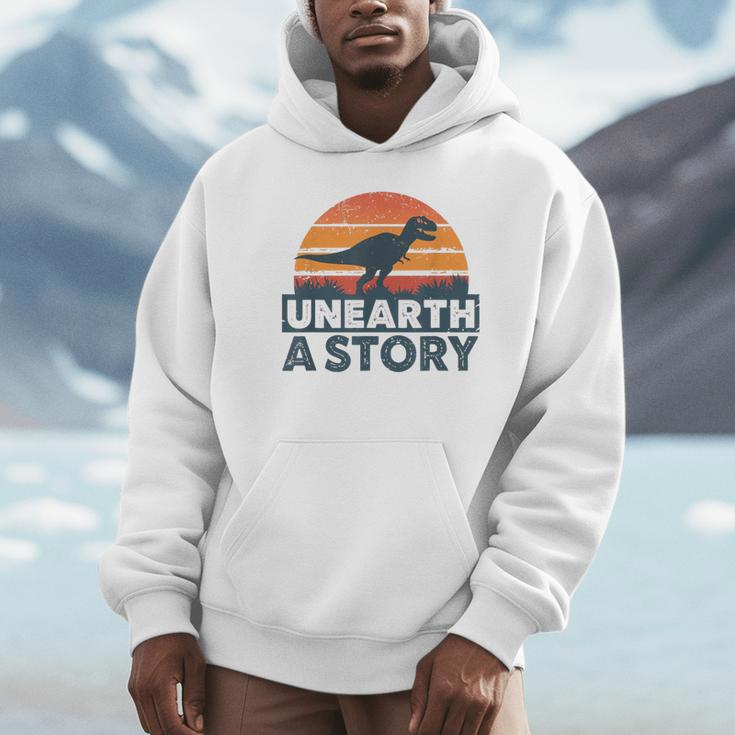 Unearth A Story Dinosaur Reader Book Lover 2026 Unisex Hoodie Unearth A Story Dinosaur Reader Book Lover 2026 Unisex Hoodie