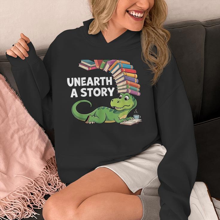 Summer Reading 2026 Unearth a Story Theme Dinosaur Book Nerd Unisex Hoodie Summer Reading 2026 Unearth a Story Theme Dinosaur Book Nerd Unisex Hoodie