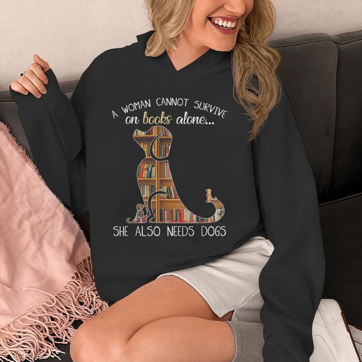 A Woman Cannot Survive On Books Alone She Also Needs Dogs Unisex Hoodie A Woman Cannot Survive On Books Alone She Also Needs Dogs Unisex Hoodie