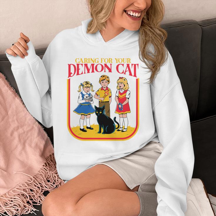 Caring For Your Evil Cat Retro Dark Humor Book Cover Premium Tri-Blend Unisex Hoodie