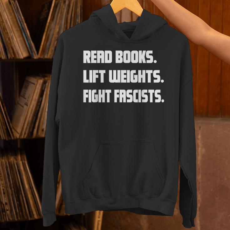 Read Books Lift Weights Fight Fascists Reading Activism Meme Unisex Hoodie Read Books Lift Weights Fight Fascists Reading Activism Meme Unisex Hoodie