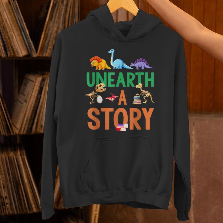 Summer Reading 2026 Dinosaurs Book Lover Unearth A Story Unisex Hoodie