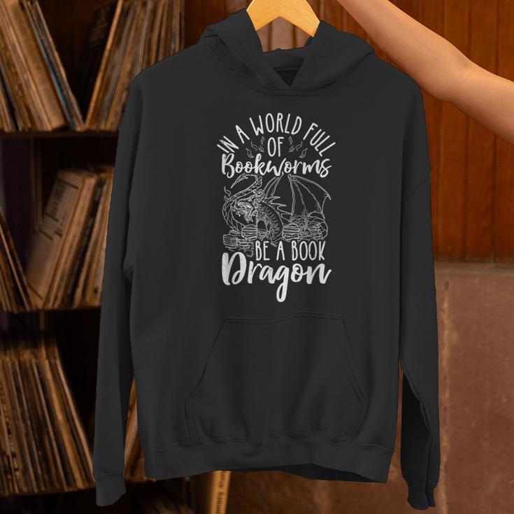IN A WORLD FULL OF BOOKWORMS BE A Book Dragon Reader Unisex Hoodie