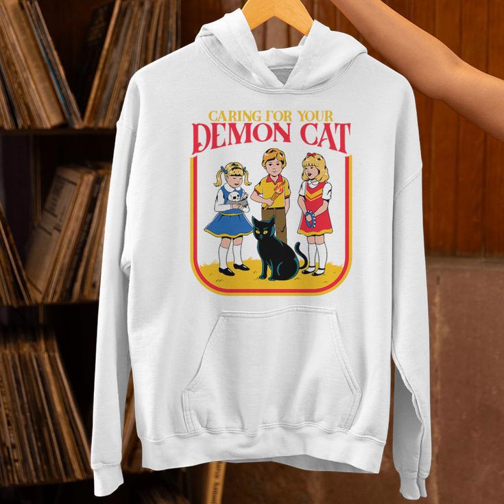 Caring For Your Evil Cat Retro Dark Humor Book Cover Premium Tri-Blend Unisex Hoodie