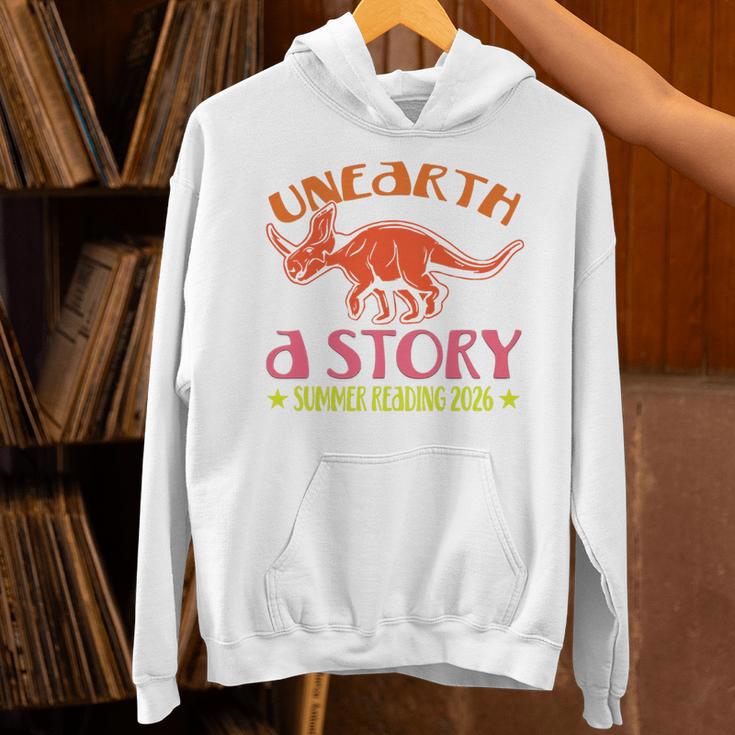 Unearth a Story Summer Reading 2026 Triceratops Dino Book Premium Tri-Blend Unisex Hoodie