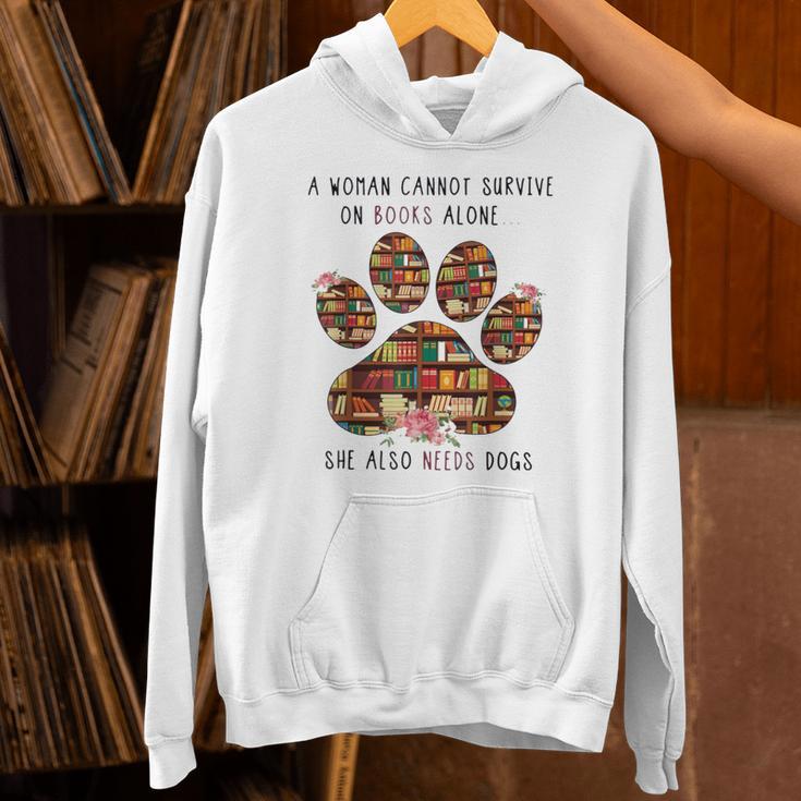 A Woman Cannot Survive On Books Alone She Also Needs Dog Unisex Hoodie A Woman Cannot Survive On Books Alone She Also Needs Dog Unisex Hoodie
