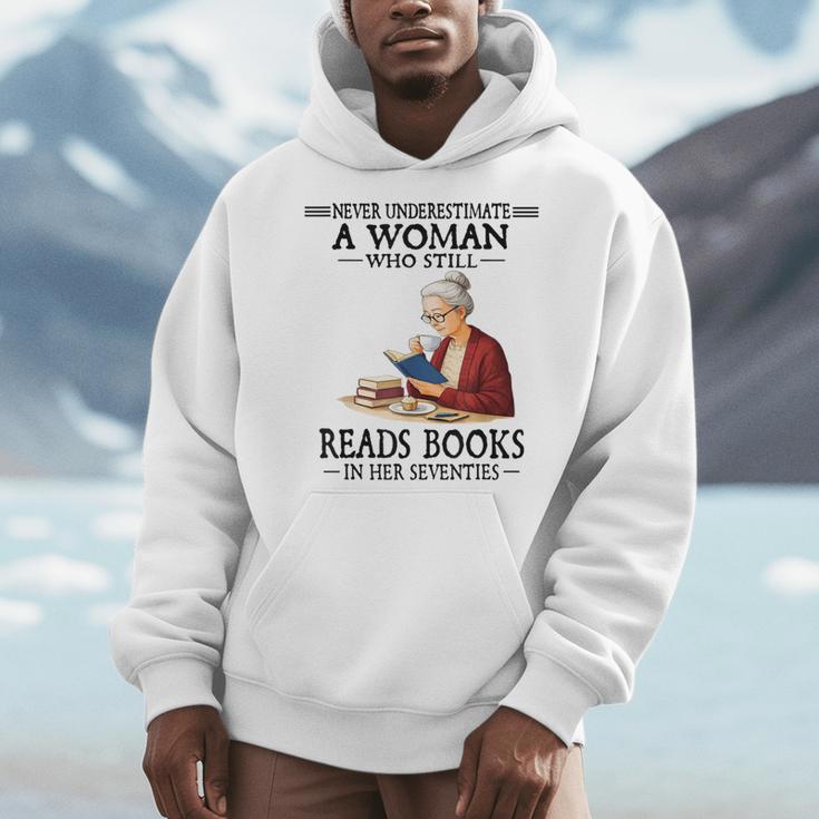 Never Underestimate A Woman Who Still Reads Books In Her Men Hoodie