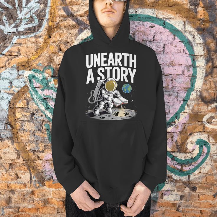 Unearth A Story Astronaut Finds Book On The Moon Men Hoodie
