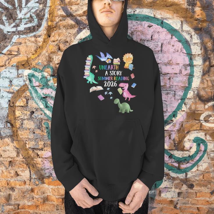 Unearth a Story Dinosaur Book 2026 Summer Reading Program Men Hoodie Unearth a Story Dinosaur Book 2026 Summer Reading Program Men Hoodie