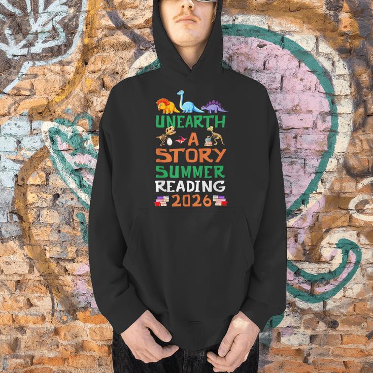 Unearth A Story Summer Reading Program 2026 Dinosaur Book Men Hoodie Unearth A Story Summer Reading Program 2026 Dinosaur Book Men Hoodie