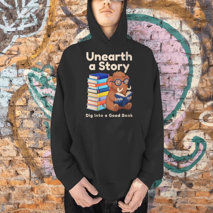 Women's Unearth A Story Reading Mammoth Prehistoric Book Librarian Men Hoodie Women's Unearth A Story Reading Mammoth Prehistoric Book Librarian Men Hoodie
