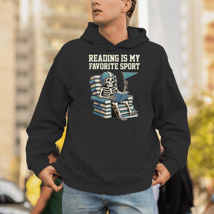 Football Skeleton Reading On Book Stack Men Hoodie