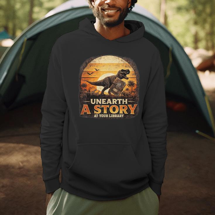 Unearth Story Summer Reading 2026 Dinosaurs Library Reading Men Hoodie Unearth Story Summer Reading 2026 Dinosaurs Library Reading Men Hoodie