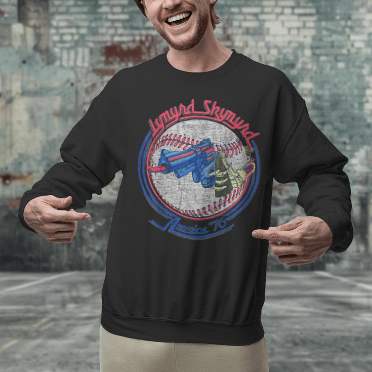Lynyrd Skynyrd Skeleton Baseball Gun US Flag Cowboy Rock Fan Unisex Sweatshirt Lynyrd Skynyrd Skeleton Baseball Gun US Flag Cowboy Rock Fan Unisex Sweatshirt