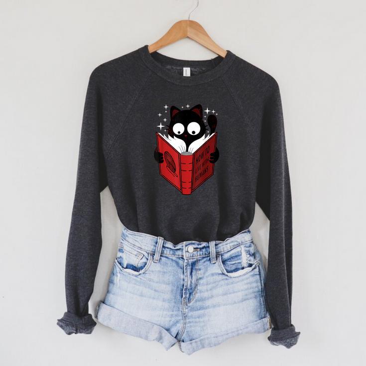 Cat Reads Book How To Live With Humans Raglan Sleeve Sweatshirt