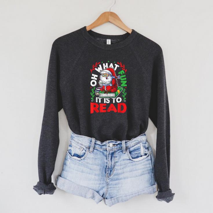 What Fun It Is To Read Books Christmas Santa Reading Books Raglan Sleeve Sweatshirt