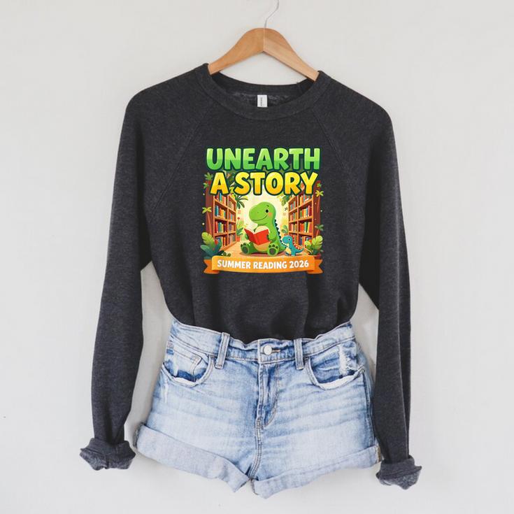 Unearth A Story Dinosaur Summer Reading 2026 Books Raglan Sleeve Sweatshirt