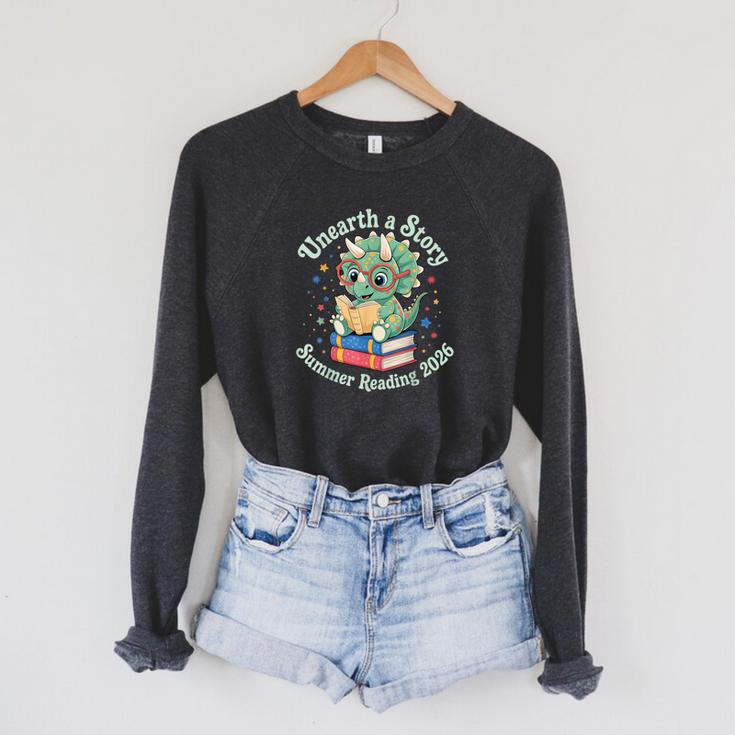 Unearth a Story Summer Reading 2026 Cute Dinosaur Book Lover Raglan Sleeve Sweatshirt