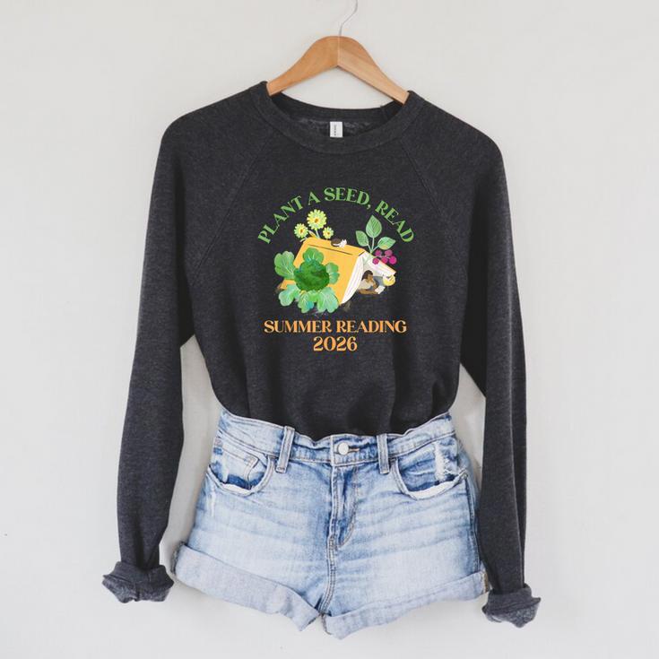 Unearth a Story Summer Reading 2026 Dinosaur Book Kids Raglan Sleeve Sweatshirt