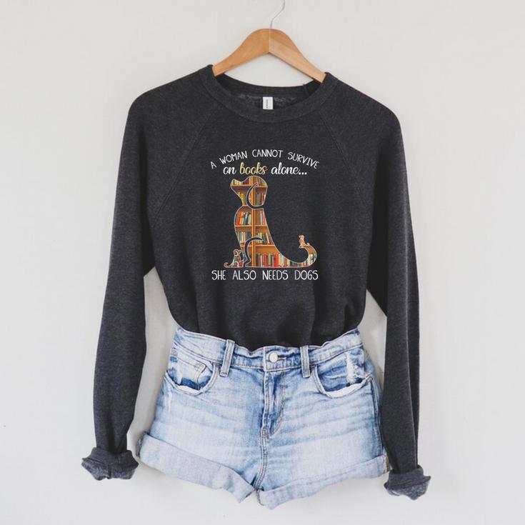 A Woman Cannot Survive On Books Alone She Also Needs Dogs Raglan Sleeve Sweatshirt