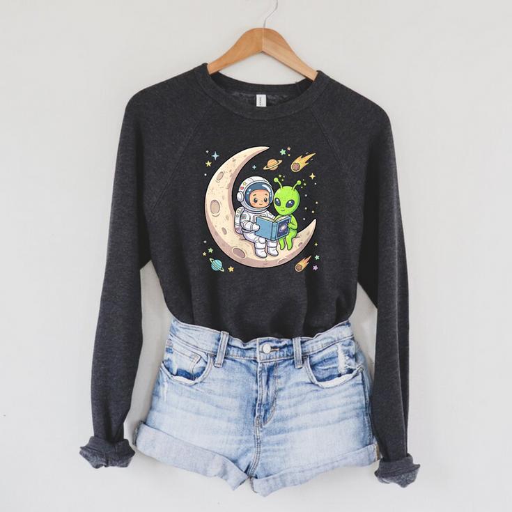 Women's Astronaut Reading Book With Alien Moon Space Astronomy Raglan Sleeve Sweatshirt