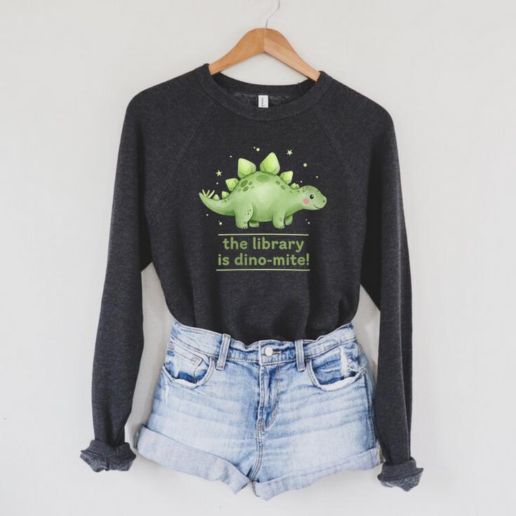Women's The Library Is Dino-Mite Stegosaurus Reading Kids Book Raglan Sleeve Sweatshirt