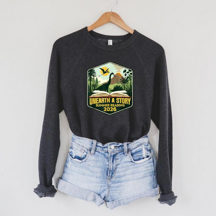 2026 Summer Reading Unearth a Story Teachers Students Book Raglan Sleeve Sweatshirt