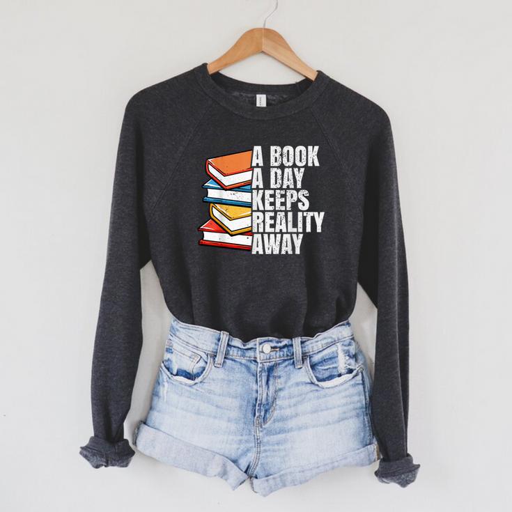 A Book A Day Keeps Reality Away Bookworm Raglan Sleeve Sweatshirt