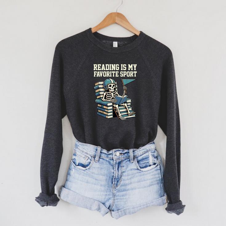 Football Skeleton Reading On Book Stack Raglan Sleeve Sweatshirt