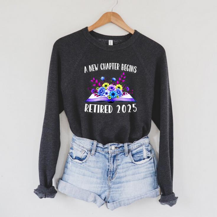 A New Chapter Begins Retired 2025 Floral Book Retirement Raglan Sleeve Sweatshirt