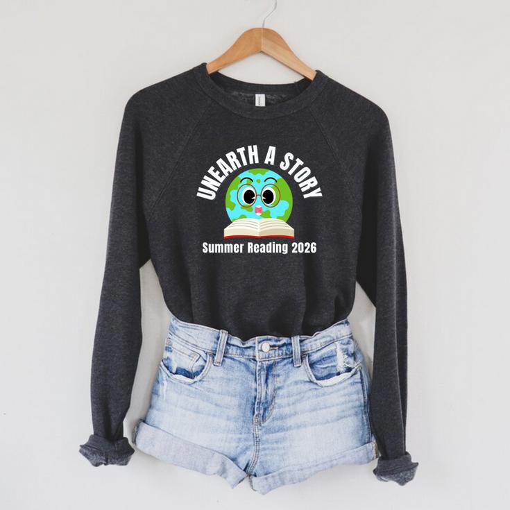 Unearth a Story Summer 2026 Reading Program Earth Read Book Premium Tri-Blend Raglan Sleeve Sweatshirt