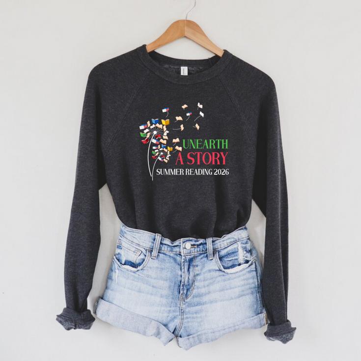Unearth a Story Summer Reading 2026 Dandelion Books Readers Premium Tri-Blend Raglan Sleeve Sweatshirt