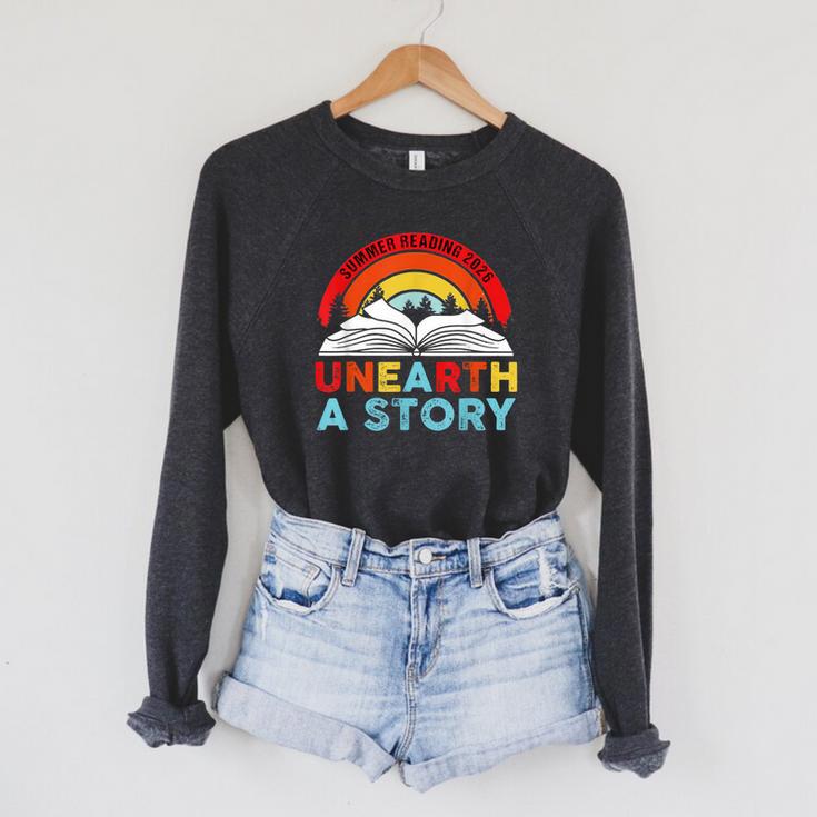Unearth a Story Summer Reading 2026 Vintage Book Rainbow Raglan Sleeve Sweatshirt Unearth a Story Summer Reading 2026 Vintage Book Rainbow Raglan Sleeve Sweatshirt