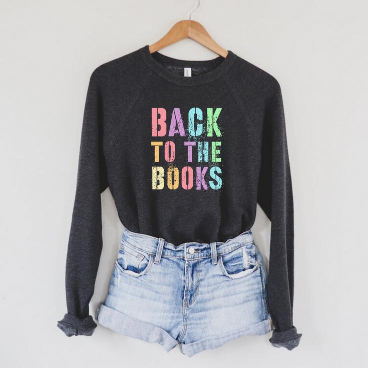 BACK TO THE BOOKS Happy First Day School Future Grads Premium Tri-Blend Raglan Sleeve Sweatshirt
