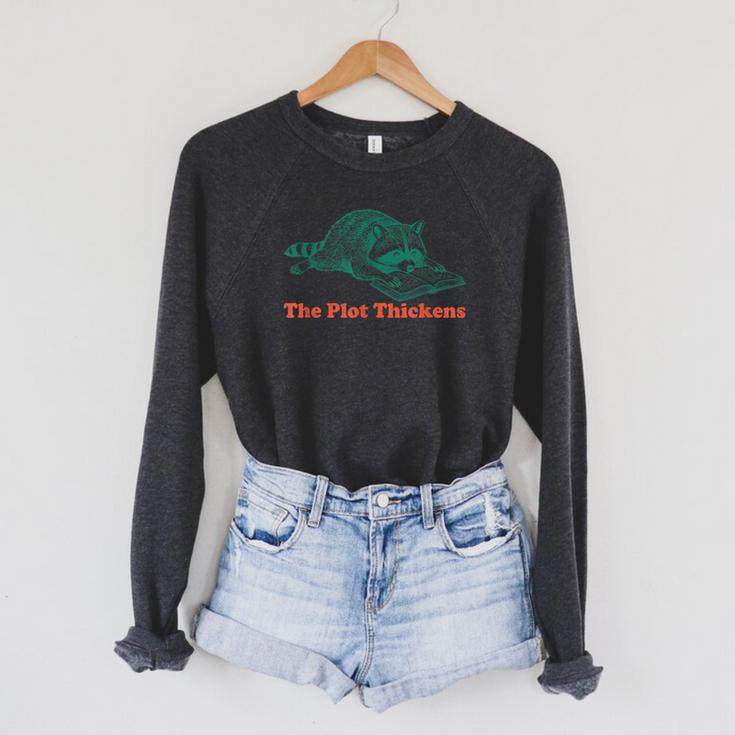 The Plot Thickens Bookish Raccoon Fantasy Book Reader Raglan Sleeve Sweatshirt