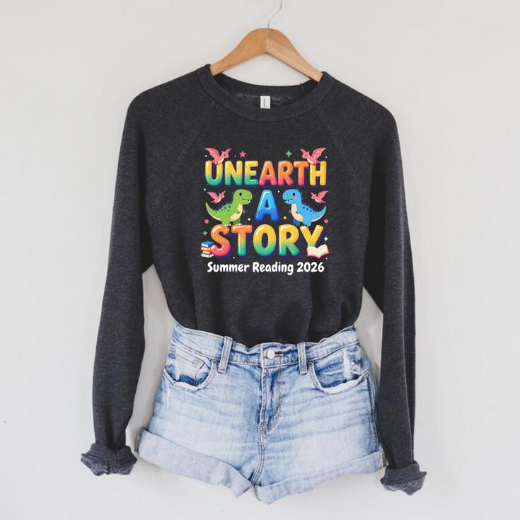 Summer Reading Unearth A Story Dinosaur Books 2026 Raglan Sleeve Sweatshirt