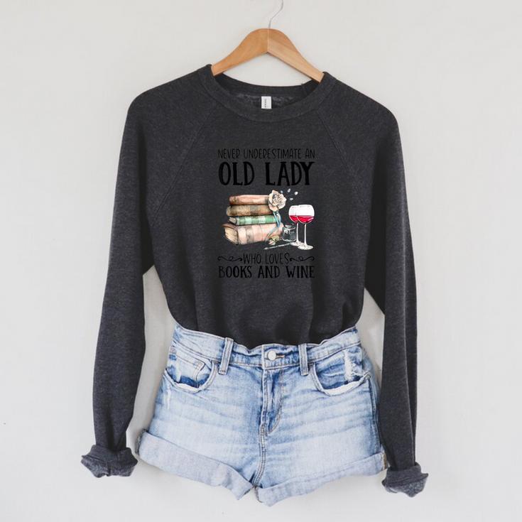 Never Underestimate An Old Lady Who Loves Books And Wine Raglan Sleeve Sweatshirt