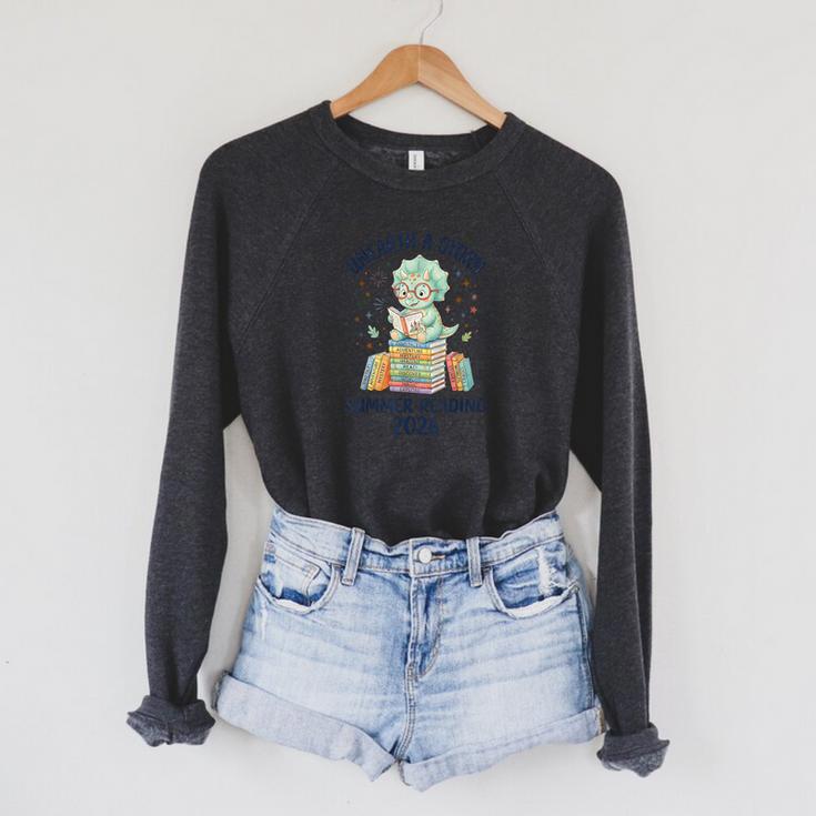 Unearth a Story Triceratops Dinosaur Reading Books Cute Dino Raglan Sleeve Sweatshirt