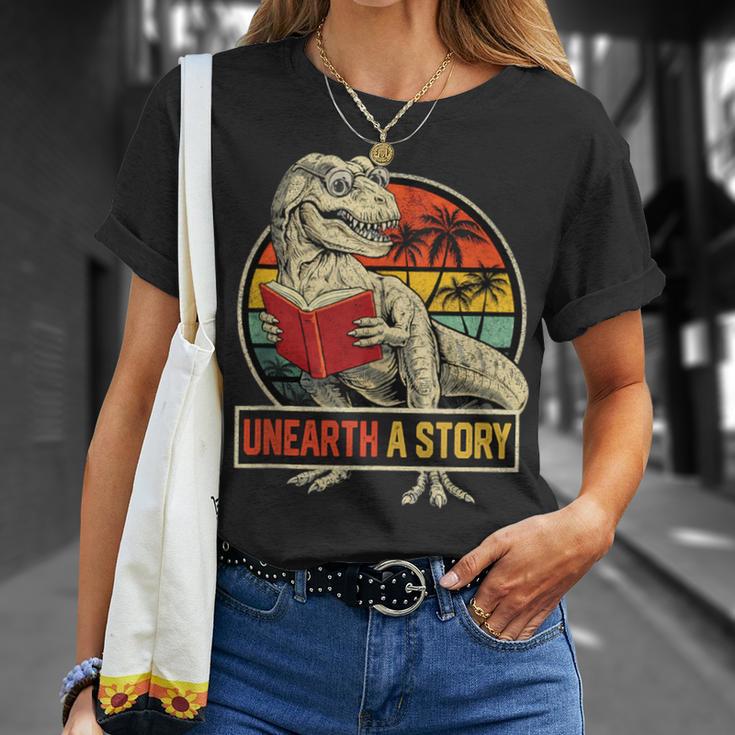 Unearth a Story Dinosaur Reading Book DinoRex Summer 2026 T-Shirt Gifts for Her Unearth a Story Dinosaur Reading Book DinoRex Summer 2026 T-Shirt Gifts for Her