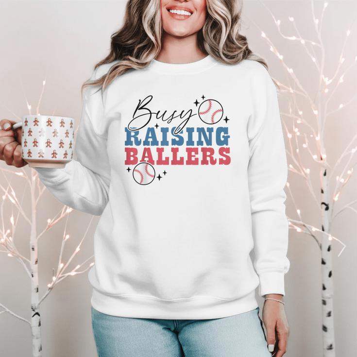 Busy Raising Ballers Retro Groovy Baseball Mom Outfit Women Crewneck Sweatshirt Busy Raising Ballers Retro Groovy Baseball Mom Outfit Women Crewneck Sweatshirt