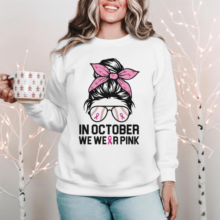 In October We Wear Pink Baseball Mom Messy Bun Breast Cancer Women Crewneck Sweatshirt In October We Wear Pink Baseball Mom Messy Bun Breast Cancer Women Crewneck Sweatshirt