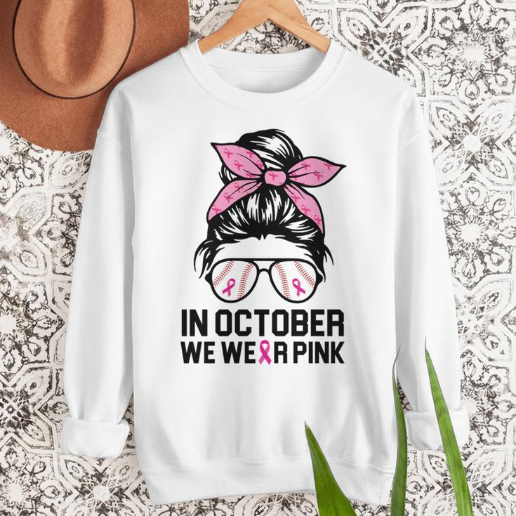 In October We Wear Pink Baseball Mom Messy Bun Breast Cancer Women Crewneck Sweatshirt In October We Wear Pink Baseball Mom Messy Bun Breast Cancer Women Crewneck Sweatshirt