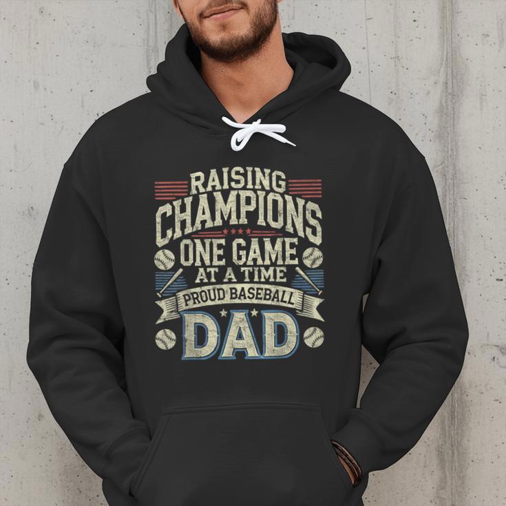Proud Baseball Dad Raising Champions One Game At A Time Men Hoodie Proud Baseball Dad Raising Champions One Game At A Time Men Hoodie