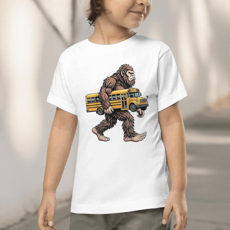 Bigfoot Carrying School Bus Sasquatch Back To School Graphic Toddler T-Shirt