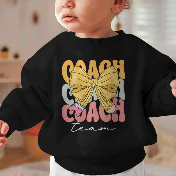 Coach Team Groovy Coquette Bow Cute Back To School Graphic Toddler Sweatshirt Coach Team Groovy Coquette Bow Cute Back To School Graphic Toddler Sweatshirt