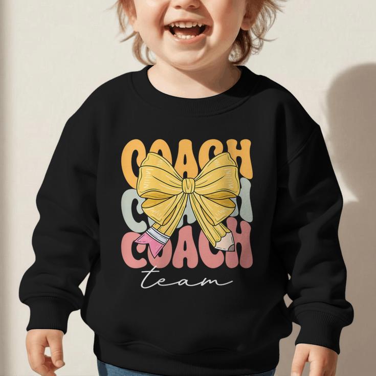 Coach Team Groovy Coquette Bow Cute Back To School Graphic Toddler Sweatshirt Coach Team Groovy Coquette Bow Cute Back To School Graphic Toddler Sweatshirt